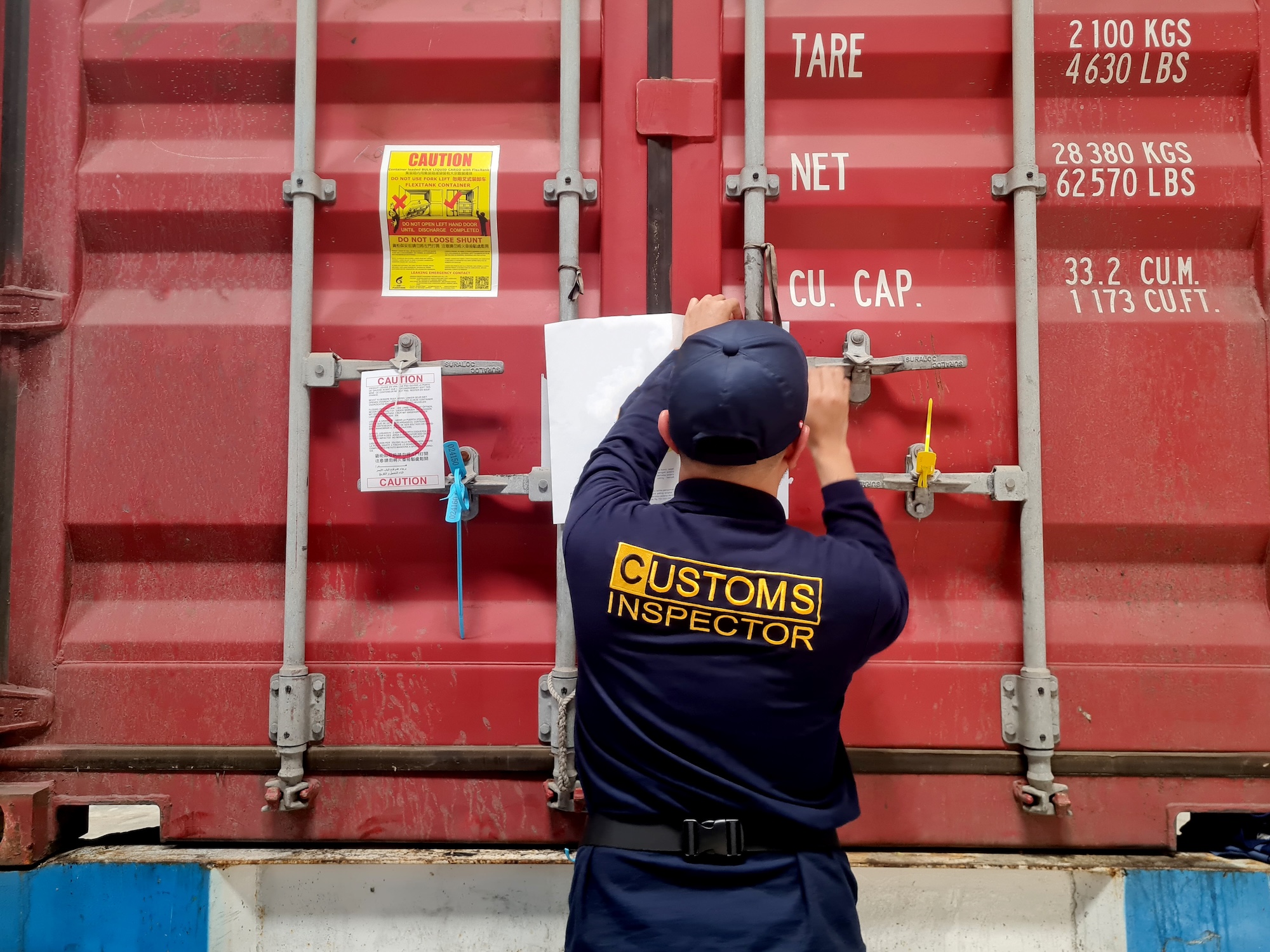 Customs officer checking for compliance with storage containers